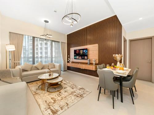 a living room with a couch and a table at Elegant 1BR I 1min walk to Burj Khalifa & Fountain in Dubai