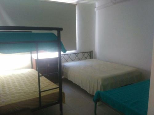 a bedroom with a bunk bed in a room at Casa LA JUANA Condominio El Cortijo in Carmen de Apicalá