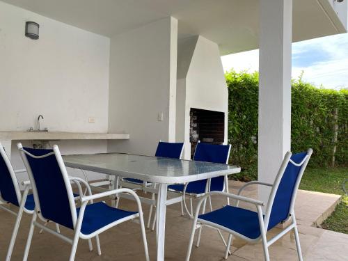a dining table and chairs on a patio at Casa LA JUANA Condominio El Cortijo in Carmen de Apicalá