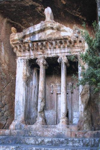 a small stone building in a stone wall at Uva Rooms in Fethiye