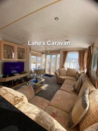 a living room with couches and a tv in a house at Southview holiday park caravan in Skegness