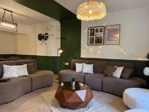 a living room with a couch and a table at JRE-EG modern aprt01SheikhZayed 5min to ArkanPlaza in Sheikh Zayed