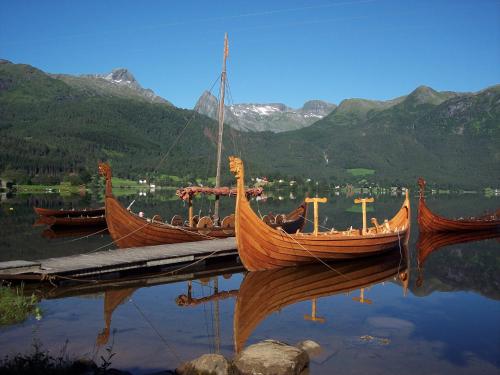 two boats are docked on a dock in the water at Volda Turisthotell in Volda