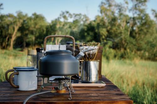a pot and pans sitting on top of a table at Monoshez Bush Camp in Nsikazi
