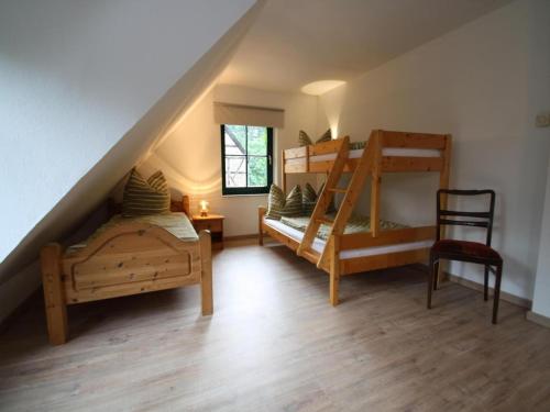 a bedroom with two bunk beds and a ladder at Doppelhaushälfte, Glave in Glave