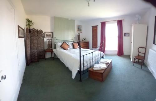a bedroom with a bed and a table in it at Hill House in Banbury