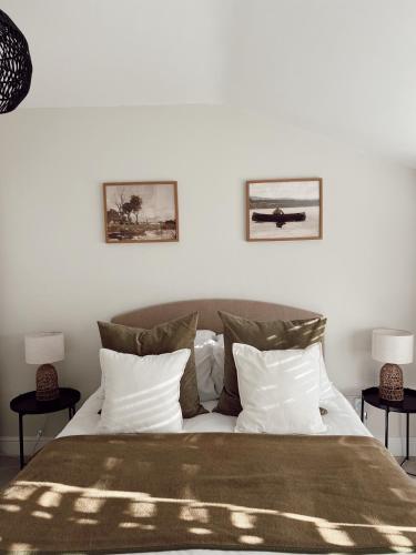 a bedroom with a large bed with two side tables at The Potting Shed in Chepstow