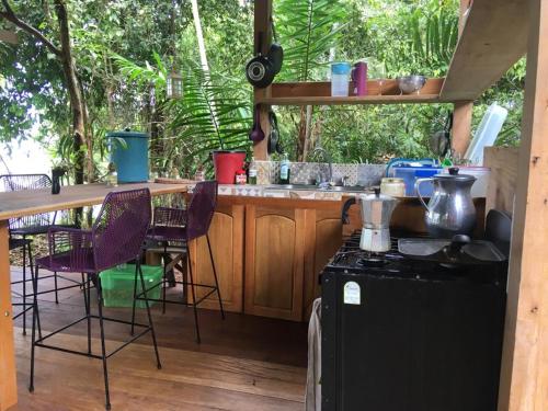 a kitchen with a counter and a table and chairs at Punta Brava in Nuquí