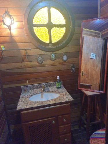 a bathroom with a sink and a window at Chalé Schueler in Nova Friburgo
