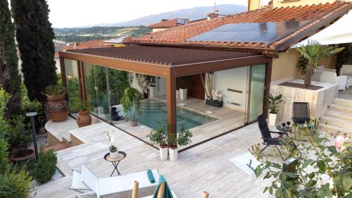 a house with a deck with a solar roof at Villa Desideria in Figline Valdarno