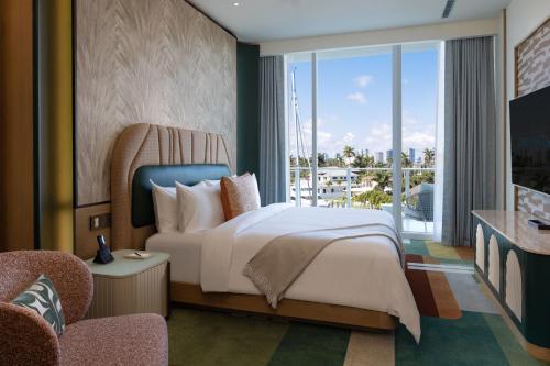 a hotel room with a bed and a balcony at Pier Sixty-Six in Fort Lauderdale