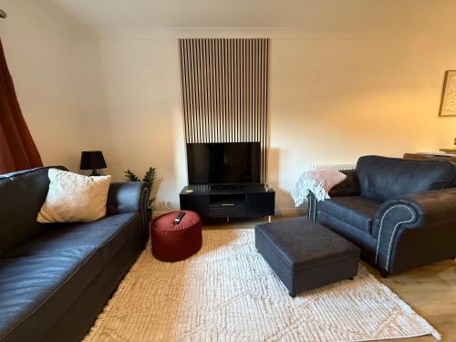a living room with a couch and a tv at In the heart of the Town centre Ringwood, New Forest - Star Cottage in Ringwood