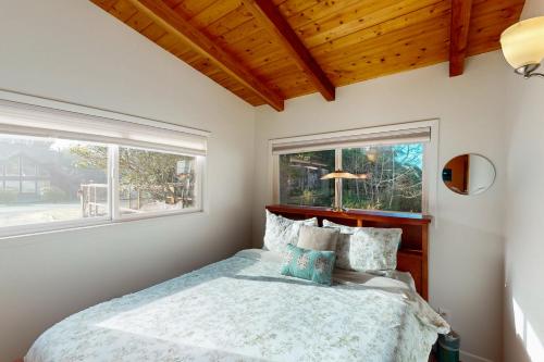 a bedroom with a bed and a window at Herb's Hideaway in Twin Rocks