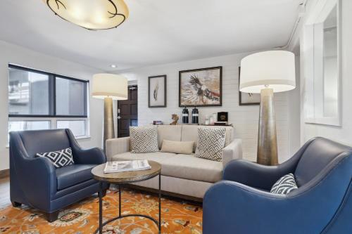 a living room with two blue chairs and a couch at Eagle Point Resort in Vail