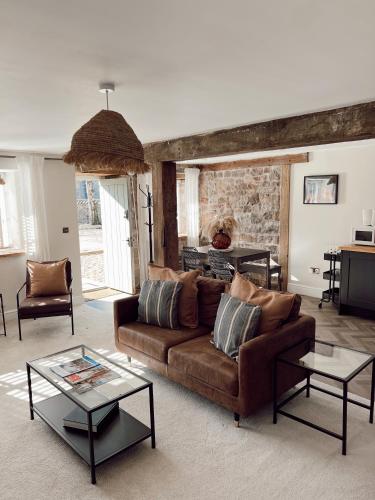 a living room with a couch and a table at Gardener's Cottage at Mathern Palace in Chepstow
