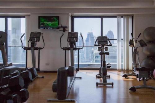 a gym with cardio equipment and a large window at Click Stay - JLT - 2 Bedroom & Balcony Lakes View Entire Apartment -SS in Dubai