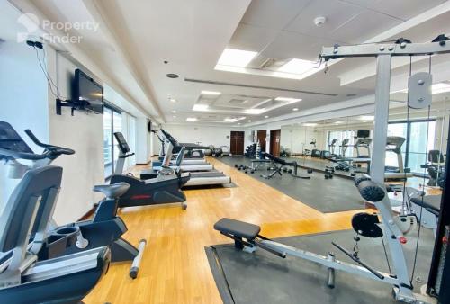 a gym with several treadmills and cardio machines at Click Stay - JLT - 2 Bedroom & Balcony Lakes View Entire Apartment -SS in Dubai