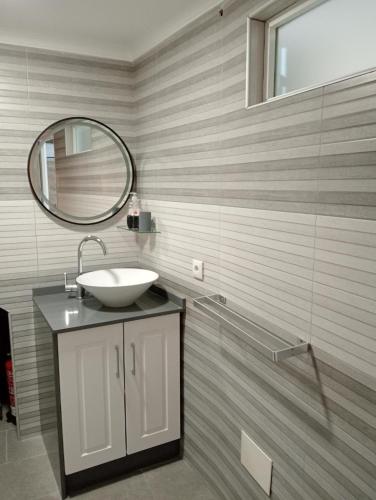 a bathroom with a sink and a mirror at Casa Marisa Padron, Camino de Santiago in Padrón
