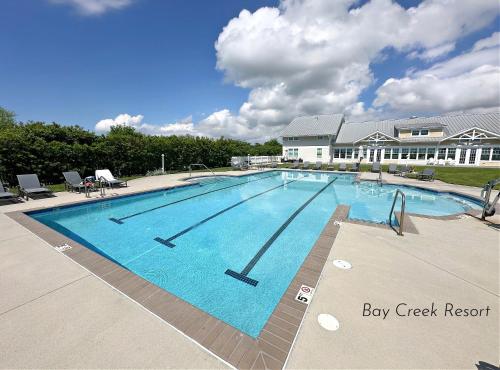 a large swimming pool in front of a building at Minchew- 5 Bedrooms, Bay Creek, Beach Access in Cape Charles