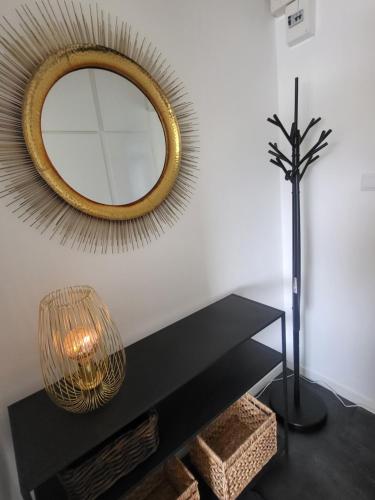 a mirror on a wall next to a black table at Sundsvall Timrå in Sundsvall