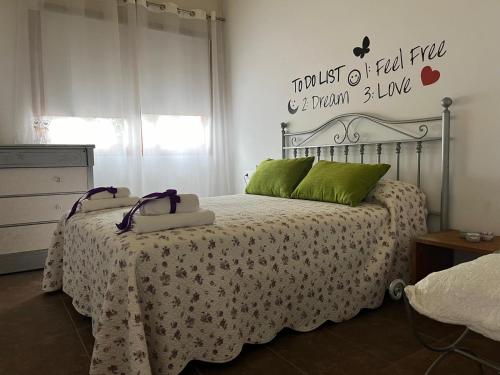 a bedroom with a bed with a white bedspread at Cal Fraguerau in Ulldemolins