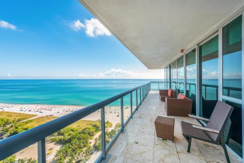 a balcony with chairs and a view of the ocean at Oceanfront Private Condo at The Setai -2707 in Miami Beach