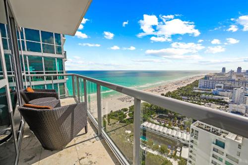 a balcony with a view of the beach and buildings at Oceanview Private Condo at The Setai -3504 in Miami Beach