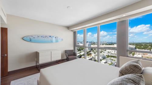 a bedroom with a bed and a large window at Oceanview Private Condo at The Setai -2202 in Miami Beach