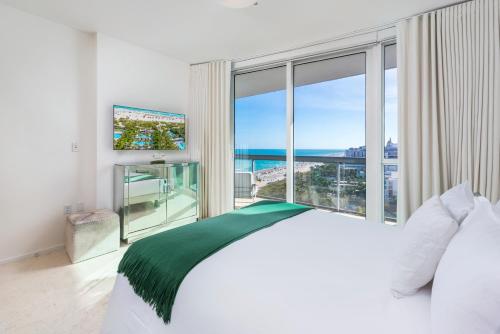 a bedroom with a bed and a large window at Oceanfront Private Condo at The Setai -2208 in Miami Beach