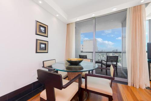 a dining room with a table and a large window at Oceanview Private Condo at The Setai -2402 in Miami Beach