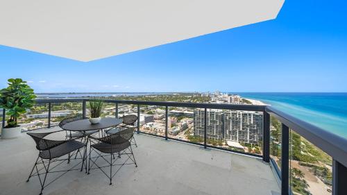 a balcony with a table and chairs and the ocean at Oceanview Private Penthouse Condo at The Setai -3903 in Miami Beach
