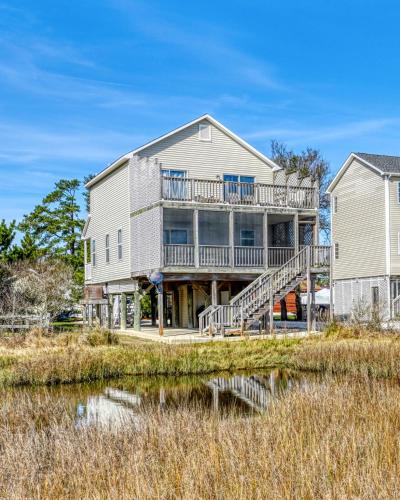 a large house with a deck and a house at Moon Rising - Waterfront with shared dock! in Black Point Landing
