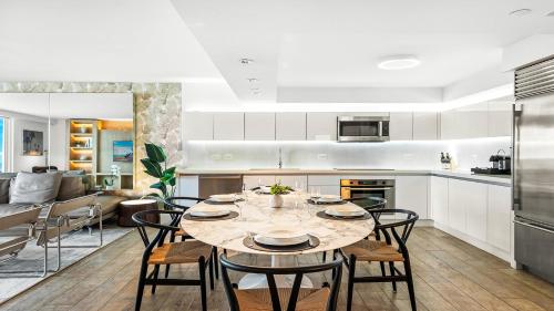 a kitchen and dining room with a table and chairs at Oceanview Private Condo at 1 Hotel & Homes -1120 in Miami Beach