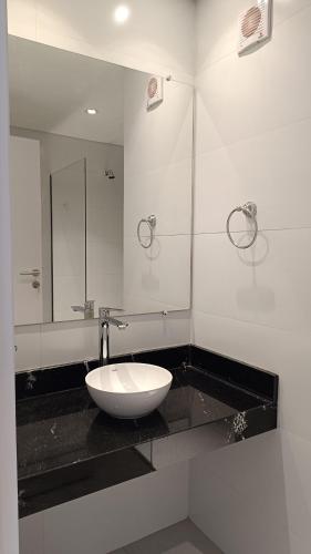 a bathroom with a white sink and a mirror at Central Relax Apartment in Encarnación
