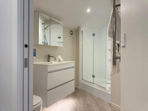 a bathroom with a sink and a shower at Bluewater Hotel in Napier