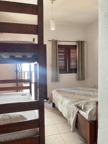 a bedroom with two bunk beds and a window at Residence Brisa in Jericoacoara