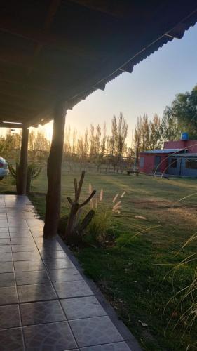 a view from under a pavilion of a grass field at Las Potrancas cabaña in General Alvear