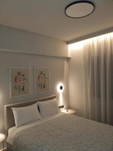 a bedroom with a large bed and a light at Simple, Calm and Luxurious in Kalamata