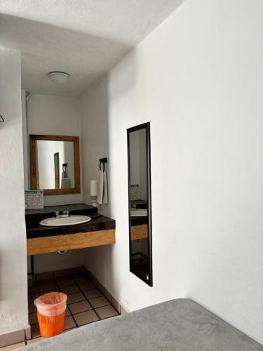 a bathroom with a sink and a mirror at Hotel bugambilias in Valle de Bravo