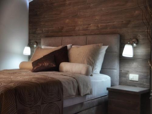 a bedroom with a bed with two lights on it at Apartments Maritea in Vodice
