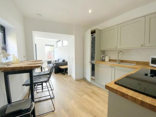 a kitchen and living room with a table and chairs at Stylish and private in the Cathedral Quarter in Lincoln
