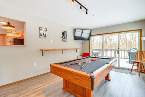 a room with a pool table and a flat screen tv at 7 Mi to Big Boulder Mtn Poconos Chalet with Hot Tub in Albrightsville