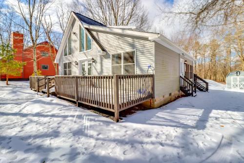 a small house with a snow covered yard at 7 Mi to Big Boulder Mtn Poconos Chalet with Hot Tub in Albrightsville