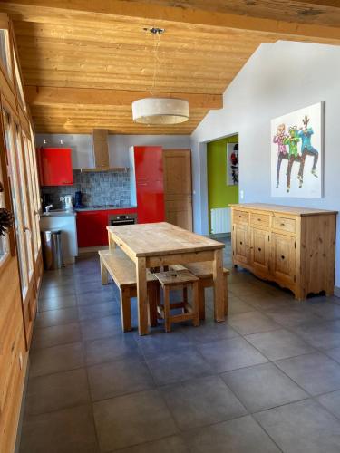 a kitchen with a wooden table and a wooden ceiling at Chalet Fleur des Alpes 1 in Les Gets