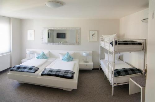 a bedroom with two bunk beds and a mirror at Hotel Adler - Weil am Rhein in Weil am Rhein