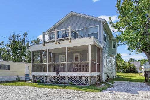 a large house with a balcony on top of it at Olive Ponies - Upper level with water Views! in Birch Town