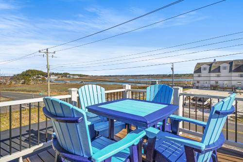 a blue table and two chairs on a porch at Olive Ponies - Upper level with water Views! in Birch Town