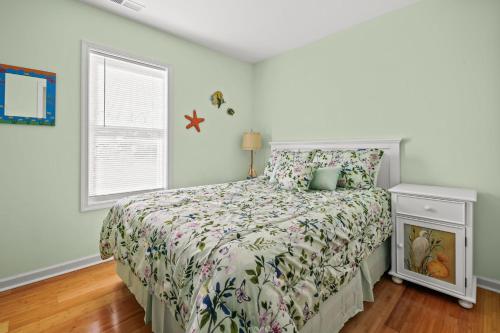 a bedroom with a bed and a window at Olive Ponies - Upper level with water Views! in Birch Town