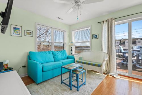 a living room with a blue couch and a table at Olive Ponies - Upper level with water Views! in Birch Town