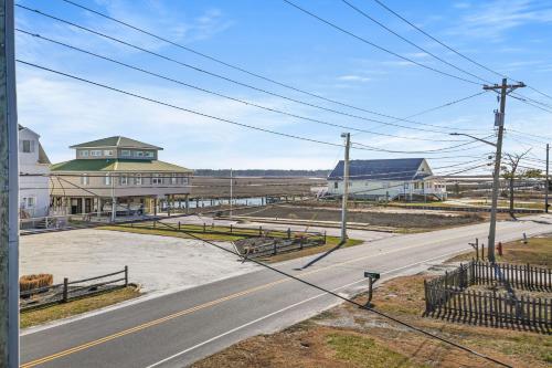 an empty road in a town with a building at Olive Ponies - Upper level with water Views! in Birch Town